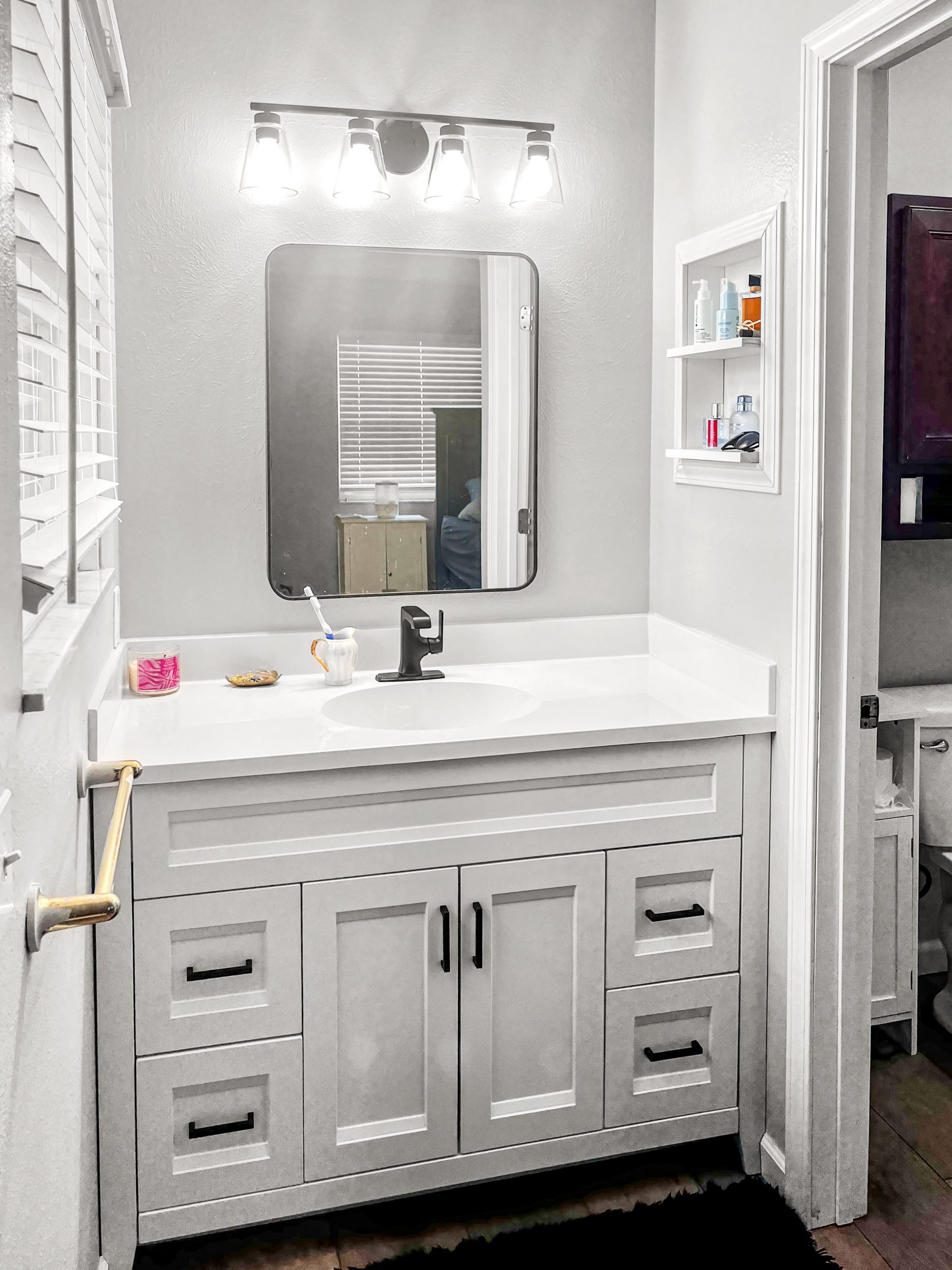 Bathroom vanity installation with mirror lighting drywall repair and shelving in Huntsville Alabama
