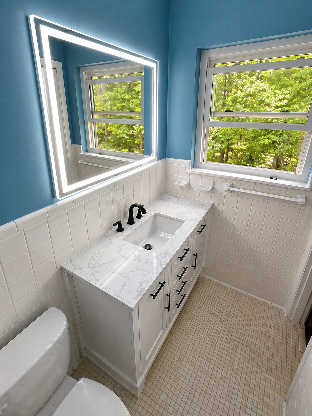 Bathroom remodel with new vanity LED mirror quartz countertop and black fixtures in Huntsville Alabama