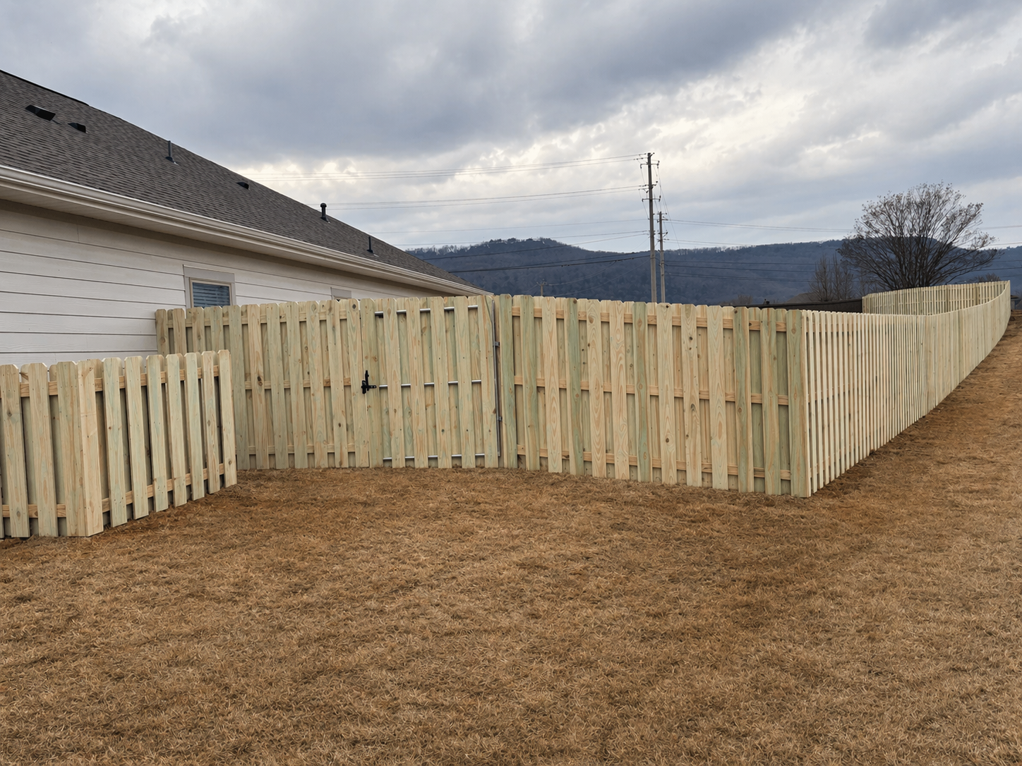 Wood privacy fence installation with gate in Owens Cross Roads Alabama by All Seasons Remodeling and Construction