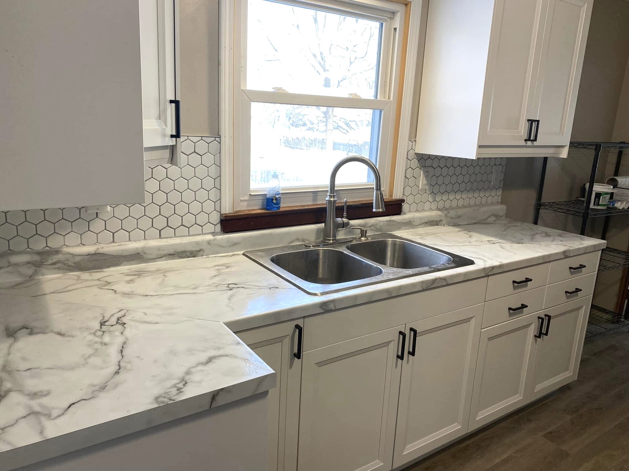 Kitchen remodel with hex tile backsplash quartz countertops and white cabinets in Huntsville Alabama