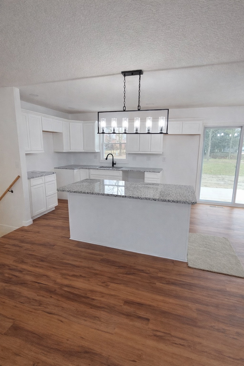 Kitchen remodel with cabinets countertops island flooring and lighting in Hampton Cove Alabama