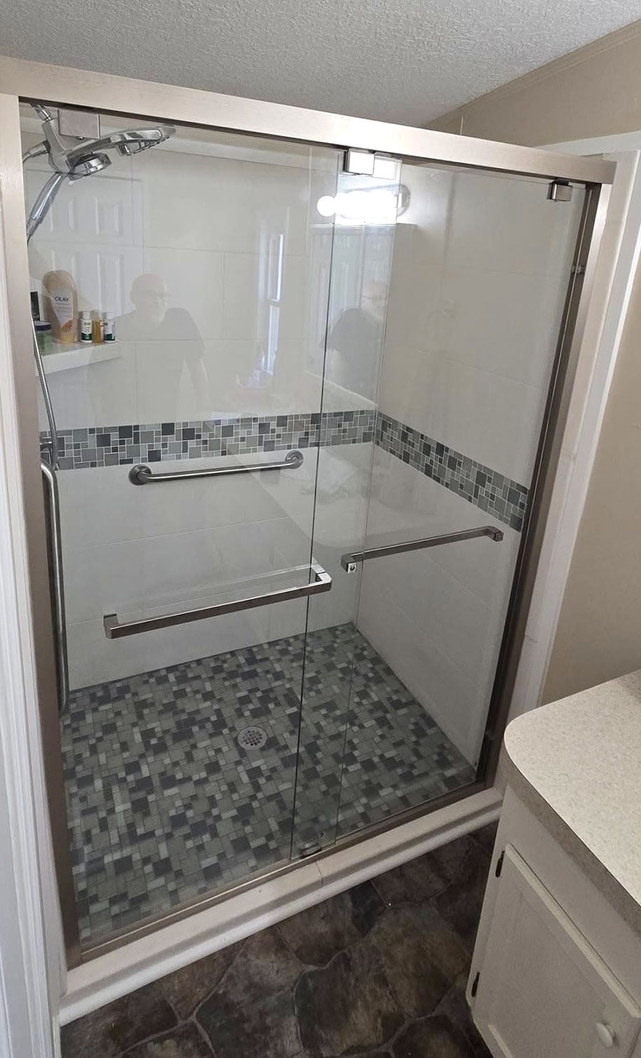 Custom shower tile installation with glass enclosure and accent tile in Huntsville Alabama