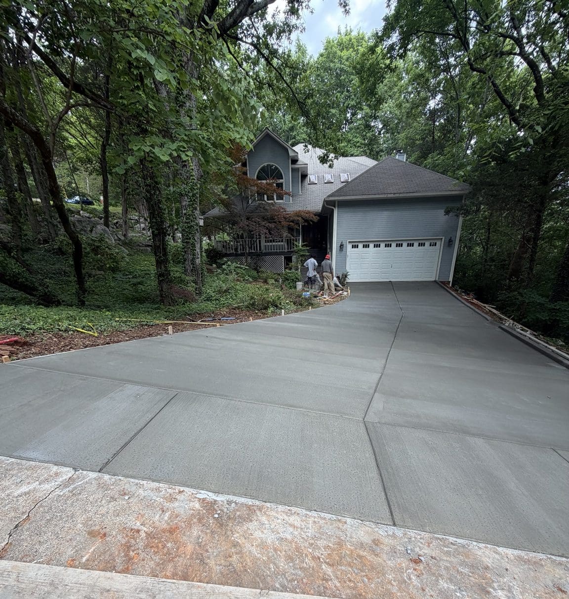 New concrete driveway installation with broom finish in Huntsville Alabama
